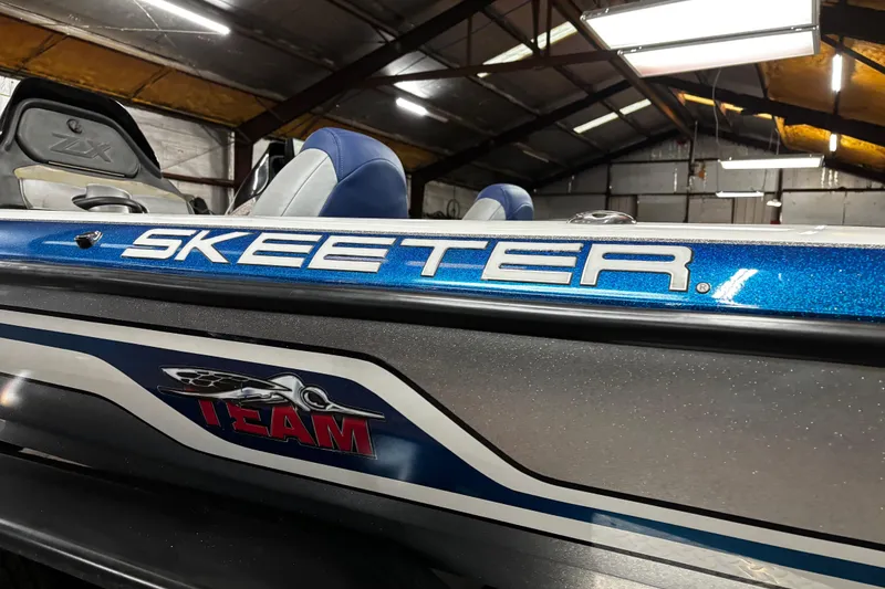 Slide: The Image of 2014 Skeeter ZX20 boat with Yamaha VMAX engine on trailer by the water. - 17