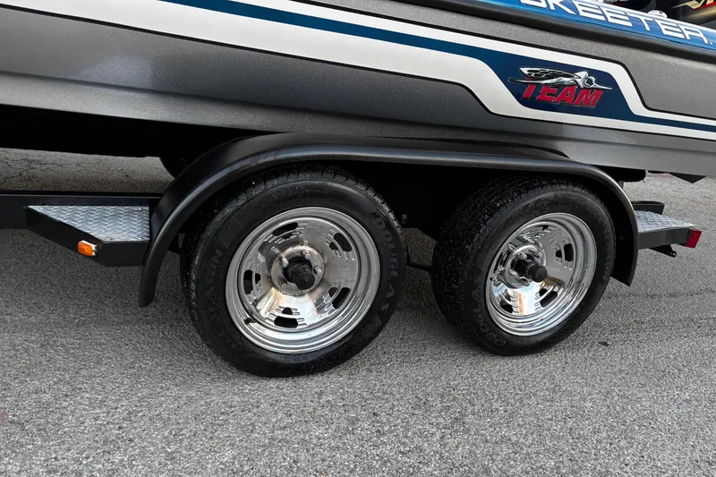 Slide: The Image of 2014 Skeeter ZX20 boat on trailer by a lake under clear blue sky. - 18