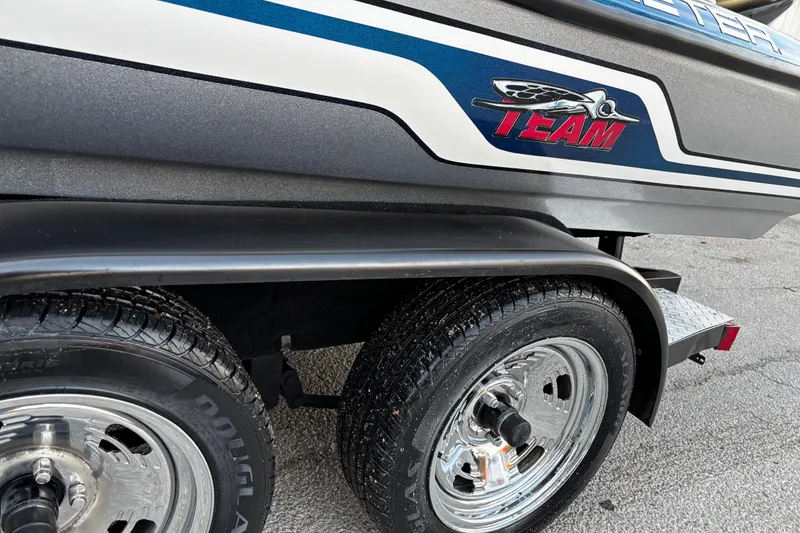 Slide: The Image of 2014 Skeeter ZX20 boat on trailer by a lake, under clear blue sky. - 19