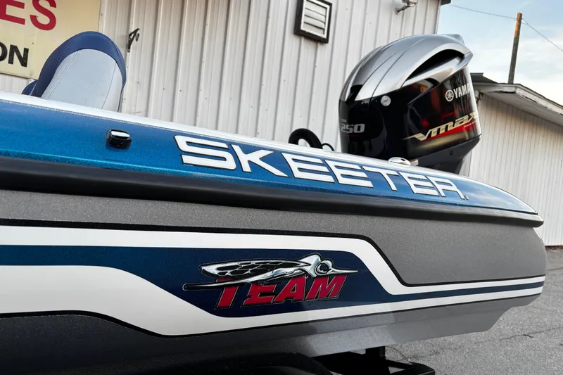 Slide: The Image of 2014 Skeeter ZX20 boat on trailer by a lake under clear blue sky. - 20