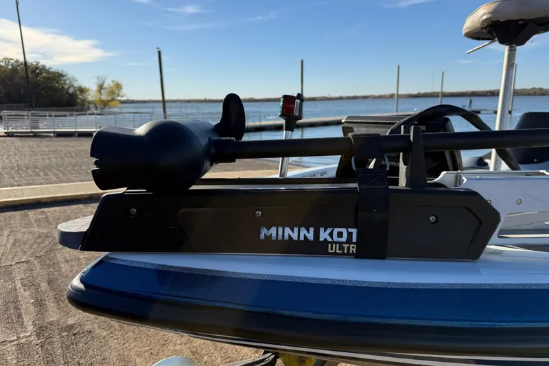 Slide: The Image of 2014 Skeeter ZX20 boat with Minn Kota Ulterra motor by a lakeside dock. - 21