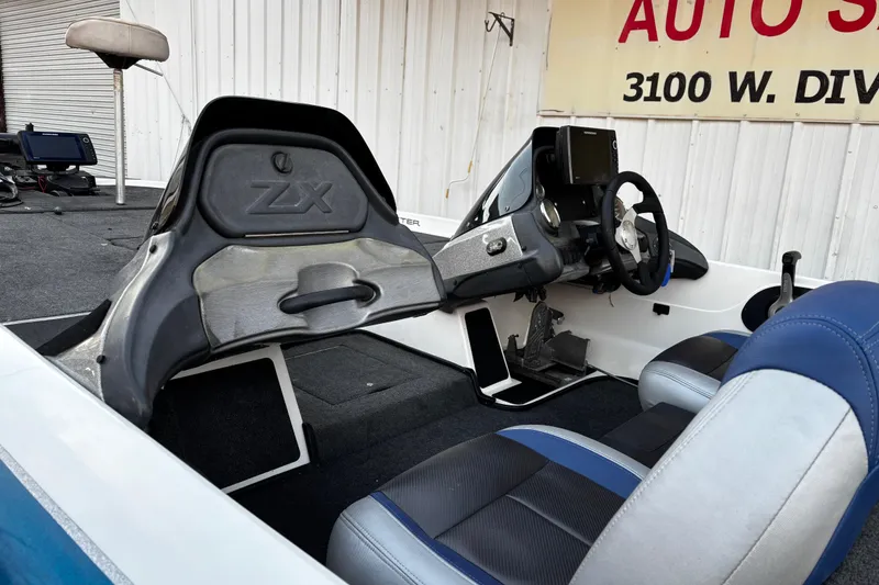 Slide: The Image of 2014 Skeeter ZX20 boat with Minn Kota trolling motor by the water. - 22