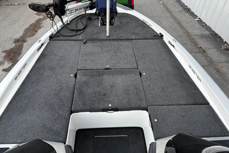 Slide: The Image of 2014 Skeeter ZX20 boat on a ramp by the water, featuring dual seats and a powerful motor. - 35