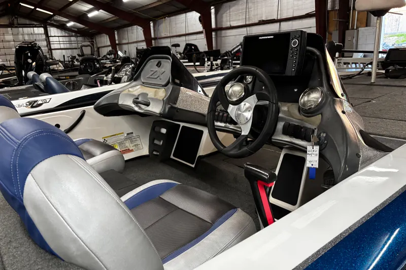 Slide: The Image of 2014 Skeeter ZX20 boat with Yamaha VMAX 250 engine, parked outdoors. - 9