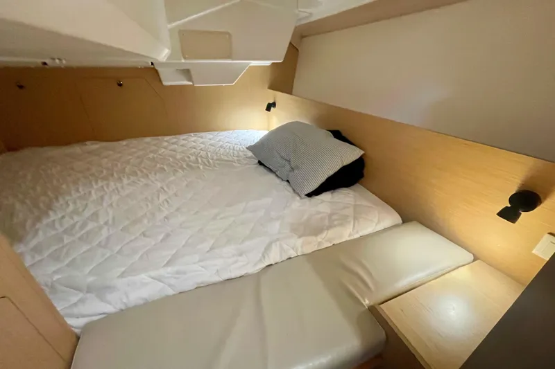 Slide: The Image of Cozy cabin interior of 2020 Beneteau Oceanis 38.1 with bed and soft lighting. - 20