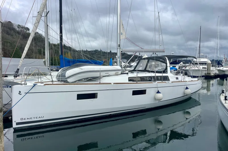 Slide: The Image of 2020 Beneteau Oceanis 38.1 sailboat docked in a marina, overcast sky. - 26