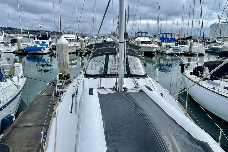 Slide: The Image of 2020 Beneteau Oceanis 38.1 yacht docked in a marina, surrounded by other boats. - 27