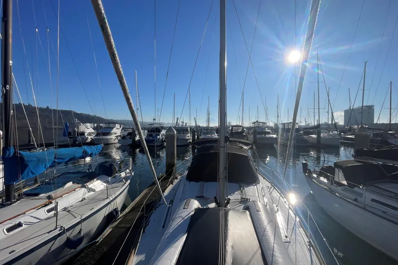 Slide: The Image of 2020 Beneteau Oceanis 38.1 sailboat docked in a sunny marina. - 29