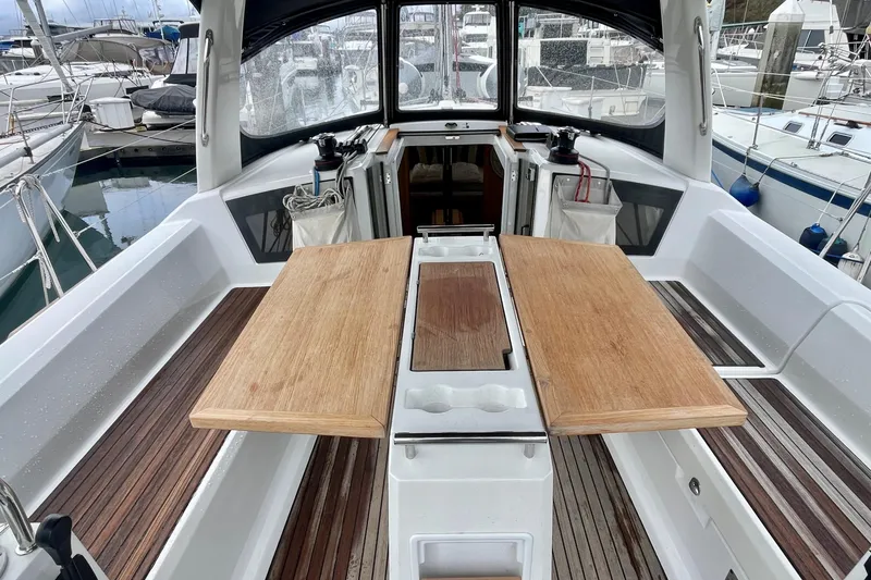 Slide: The Image of Cockpit of 2020 Beneteau Oceanis 38.1 sailboat with wooden table and seating. - 3