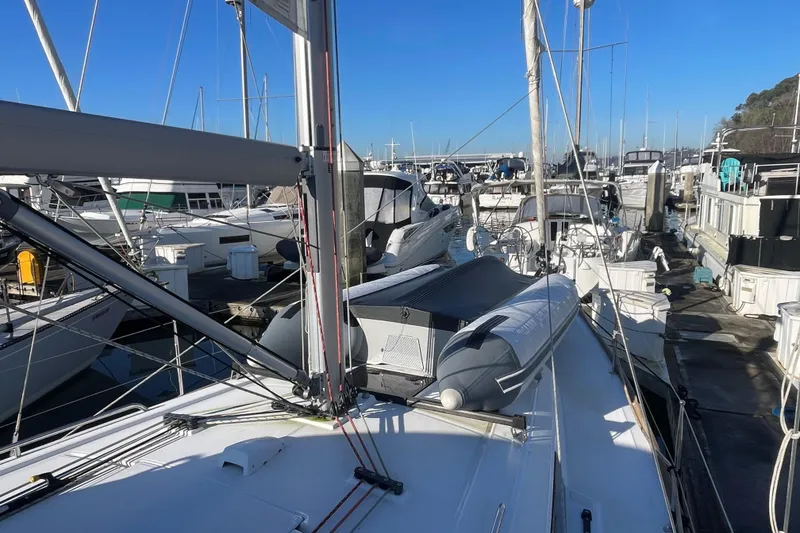 Slide: The Image of 2020 Beneteau Oceanis 38.1 sailboat docked at marina under clear blue sky. - 30