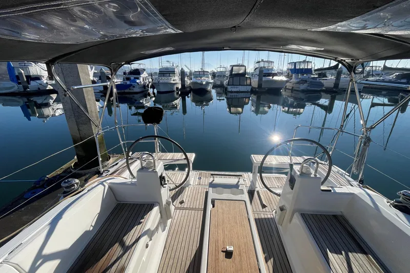 Slide: The Image of Beneteau Oceanis 38.1 yacht cockpit, 2020 model, docked in a serene marina. - 33