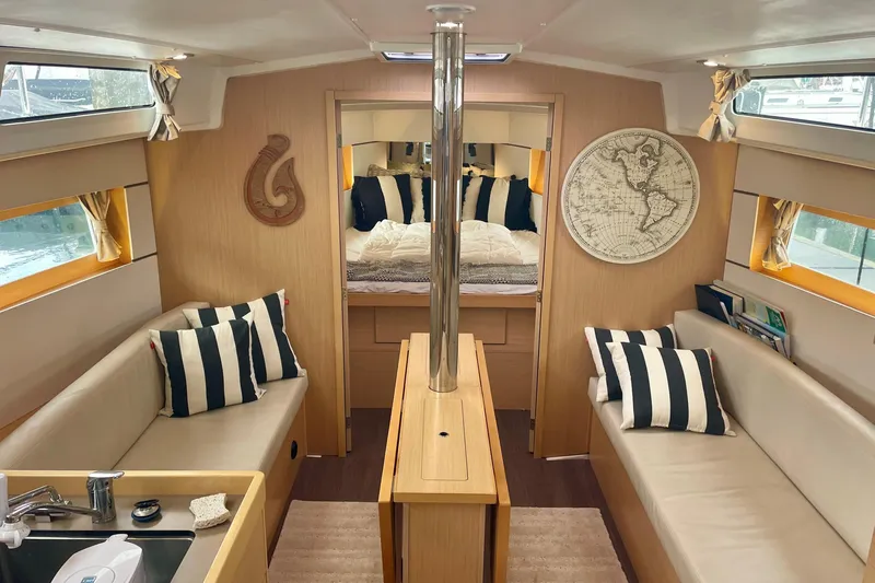 Slide: The Image of Interior of 2020 Beneteau Oceanis 38.1 yacht with cozy seating and nautical decor. - 4