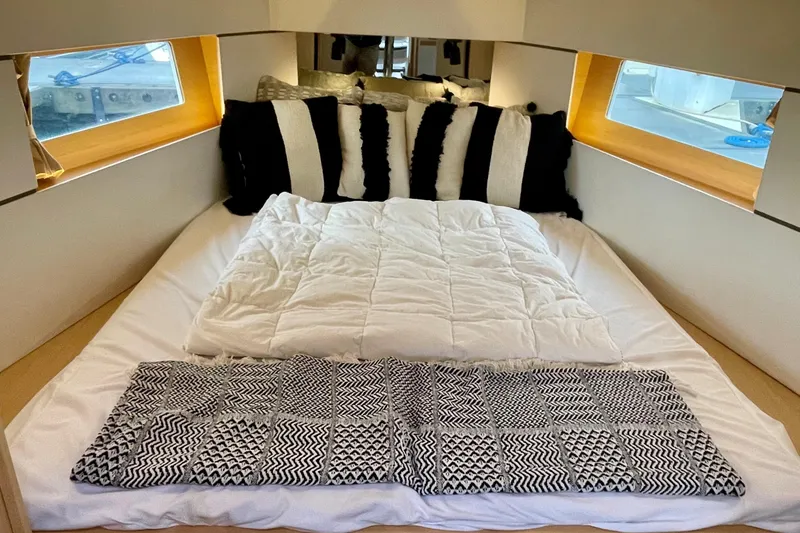 Slide: The Image of Cozy cabin interior of 2020 Beneteau Oceanis 38.1 with stylish bedding and pillows. - 5