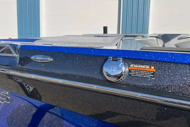 Slide: The Image of 2017 Tigé R21 boat with metallic blue finish and high octane fuel warning label. - 13