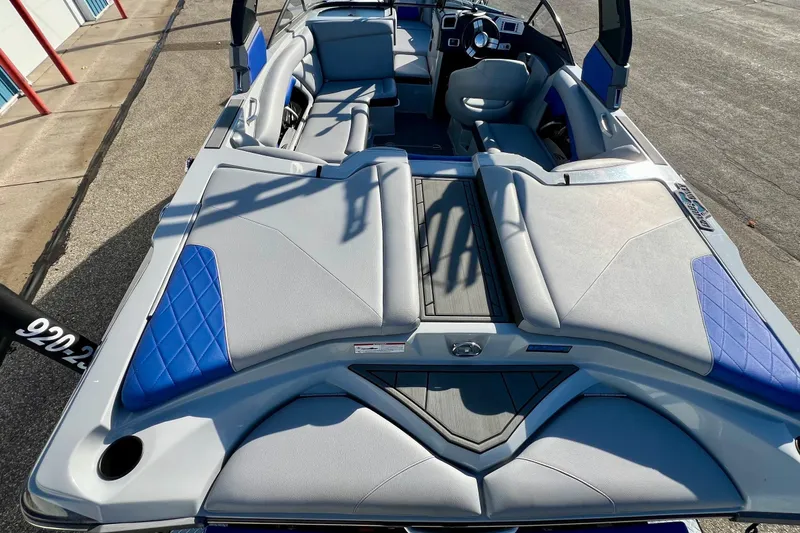 Slide: The Image of 2017 Tigé R21 boat interior with blue and gray seating, showcasing modern design. - 17