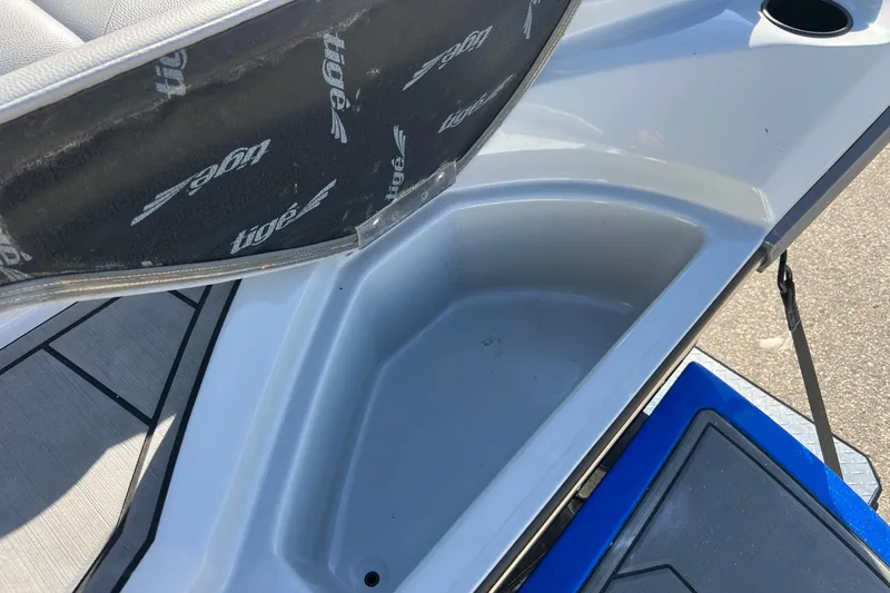 Slide: The Image of 2017 Tigé R21 boat storage compartment with open lid, showing interior space. - 21
