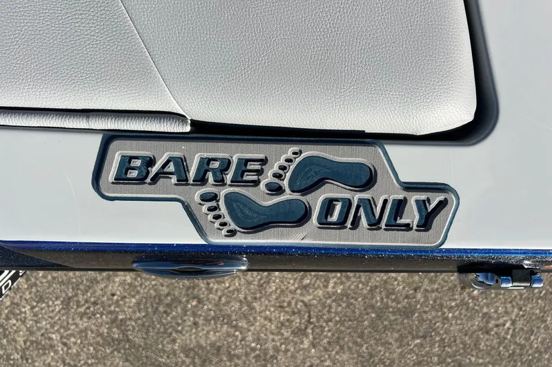 Slide: The Image of 2017 Tigé R21 boat with 'Bare Only' foot decal on white seat. - 26