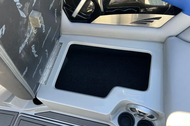 Slide: The Image of Open storage compartment in 2017 Tigé R21 boat with cup holders. - 31