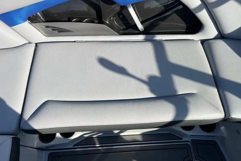 Slide: The Image of 2017 Tigé R21 boat interior with gray seating and blue accents. - 32