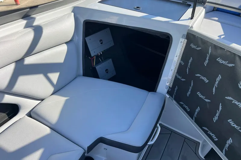 Slide: The Image of 2017 Tigé R21 boat interior with open storage compartment and cushioned seating. - 36