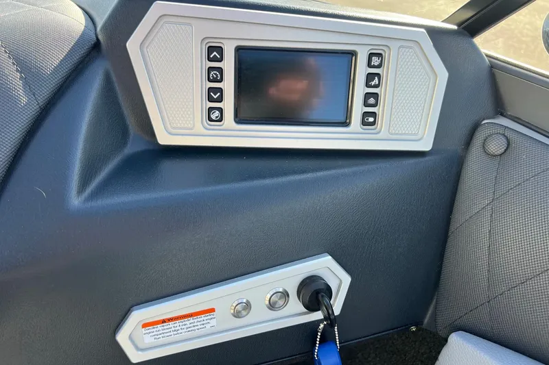 Slide: The Image of Control panel of a 2017 Tigé R21 boat with touchscreen and buttons. - 43