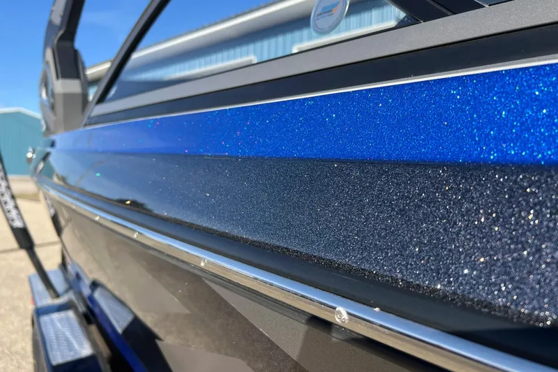 Slide: The Image of 2017 Tigé R21 boat with sparkling blue and black exterior finish. - 9