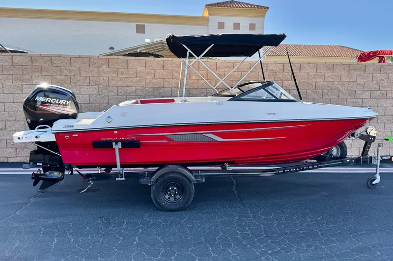 The Image of 2016 Bayliner 180 Bowrider boat with red hull and Mercury outboard motor. - 0