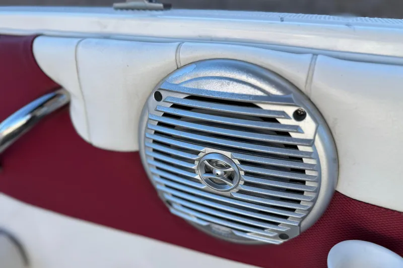 Slide: The Image of Speaker on 2016 Bayliner 180 Bowrider boat, featuring red and white interior. - 12