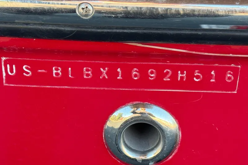 Slide: The Image of 2016 Bayliner 180 Bowrider hull identification number on red surface. - 22