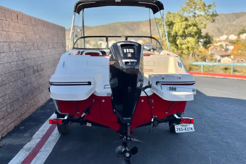 Slide: The Image of 2016 Bayliner 180 Bowrider with Mercury 115 outboard motor, parked outdoors. - 4