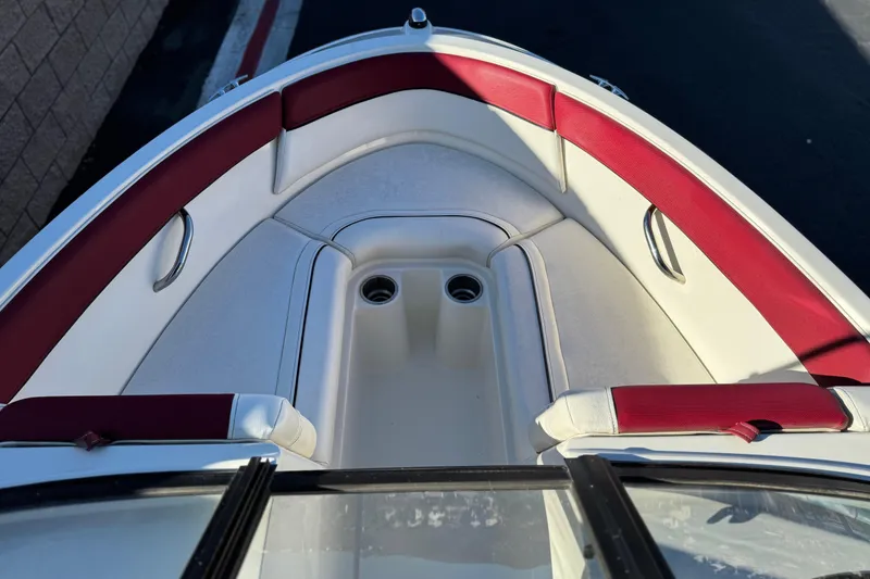Slide: The Image of 2016 Bayliner 180 Bowrider boat interior with red and white seating. - 9