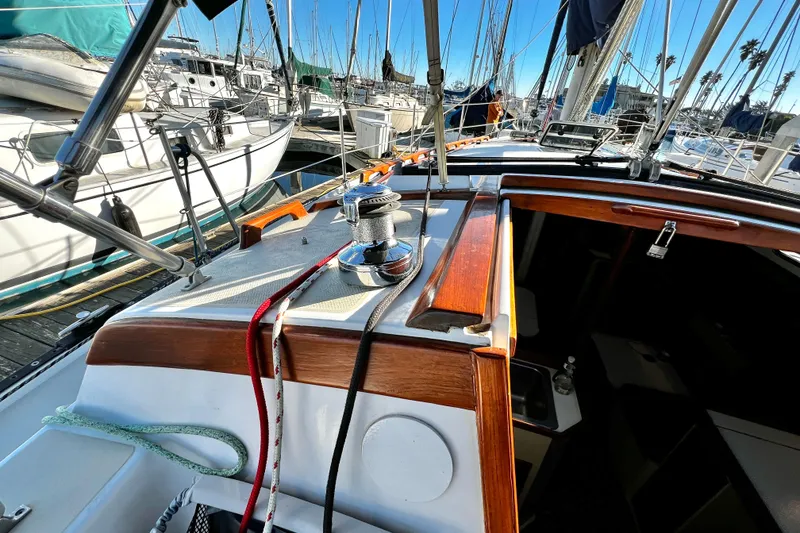 Slide: The Image of 1985 Catalina 36 sailboat cockpit with winch, ropes, and marina view. - 28