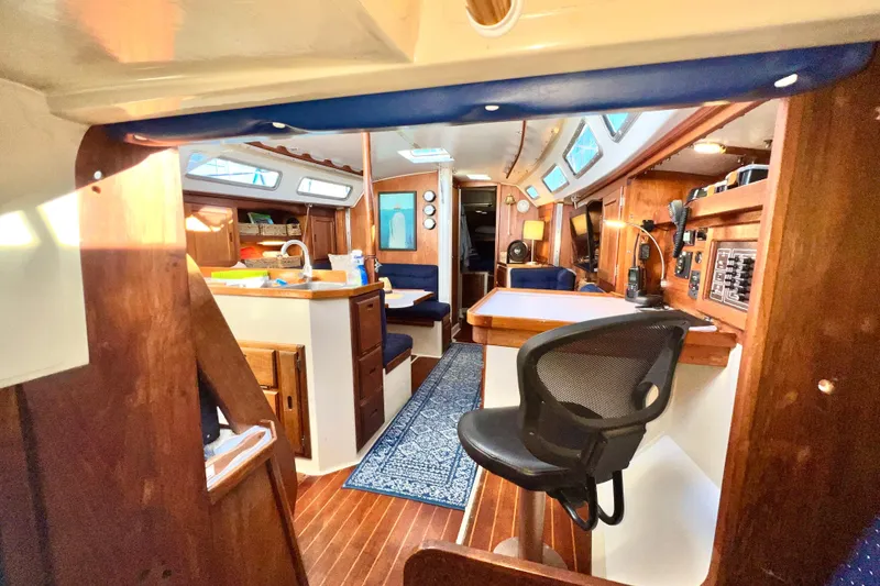 Slide: The Image of Interior of a 1985 Catalina 36 sailboat with wooden furnishings and modern amenities. - 36