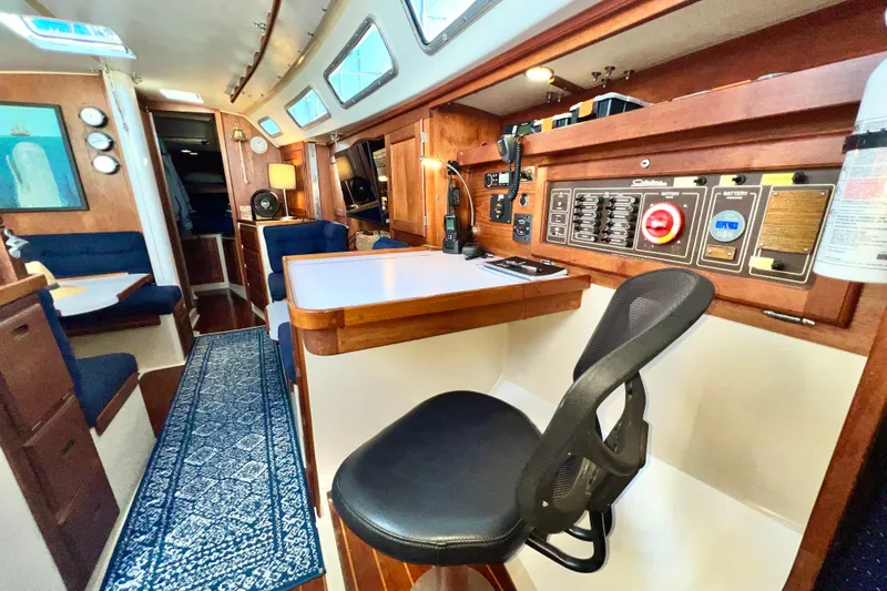 Slide: The Image of Interior of a 1985 Catalina 36 sailboat with navigation station and seating area. - 37