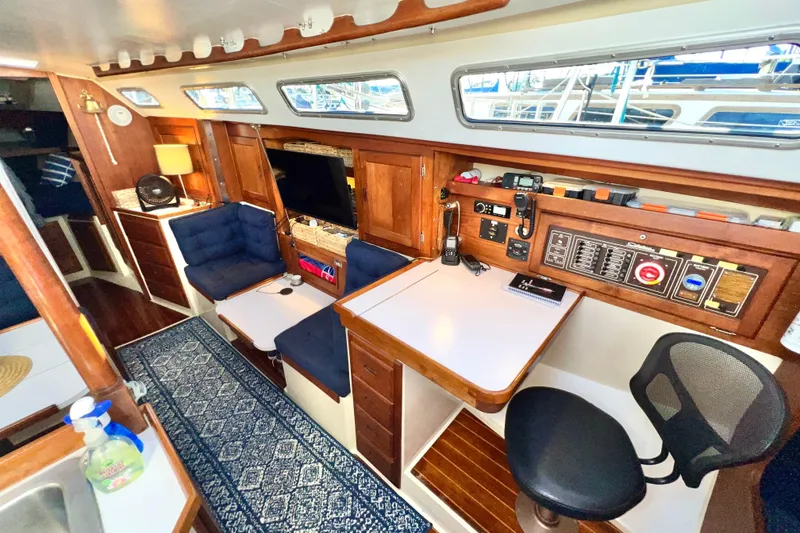 Slide: The Image of Interior of a 1985 Catalina 36 sailboat with cozy seating and navigation station. - 38