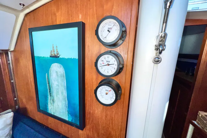 Slide: The Image of Interior of 1985 Catalina 36 sailboat with nautical artwork and gauges. - 41