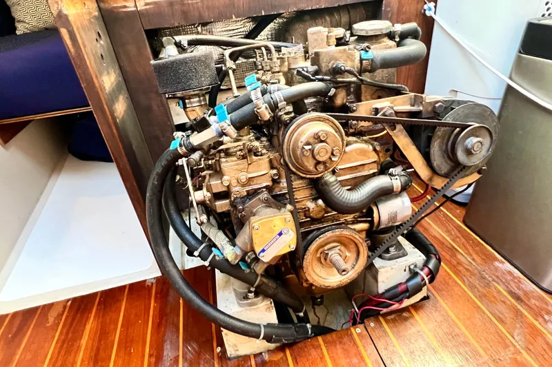 Slide: The Image of Engine of a 1985 Catalina 36 sailboat, showcasing mechanical components and belts. - 54