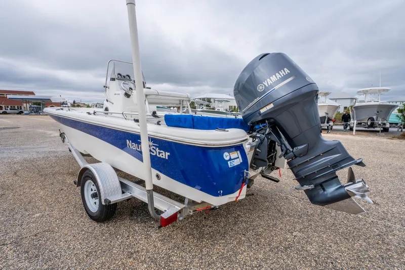 Slide: The Image of 2014 NauticStar 214 XTS boat with Yamaha outboard motor on a trailer. - 10