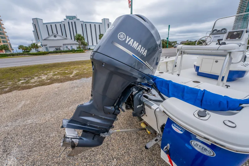 Slide: The Image of 2014 NauticStar 214 XTS boat with Yamaha outboard motor, parked near a road. - 11