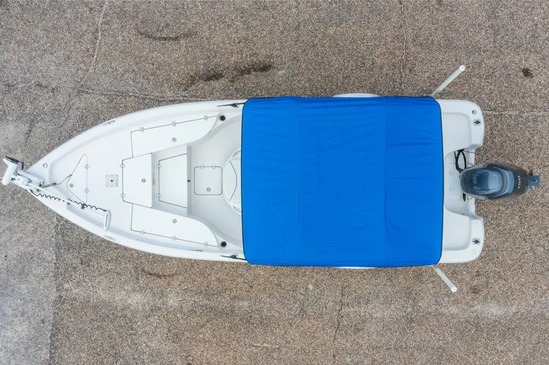 Slide: The Image of Overhead view of a 2014 NauticStar 214 XTS boat with blue cover. - 12