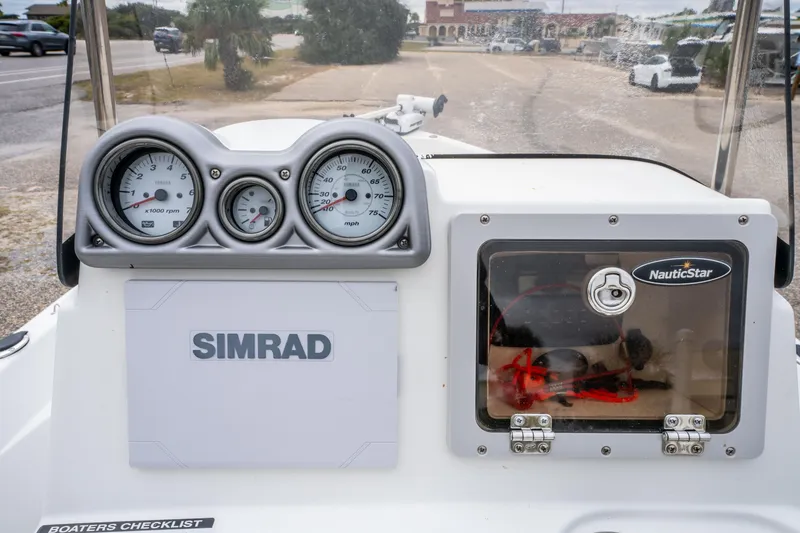 Slide: The Image of 2014 NauticStar 214 XTS boat dashboard with Simrad display and gauges. - 14