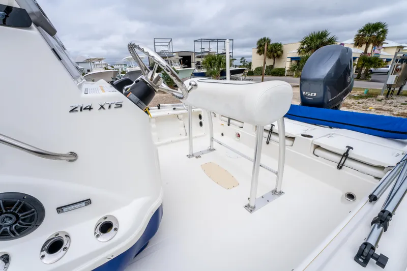 Slide: The Image of 2014 NauticStar 214 XTS boat interior with steering wheel and seating. - 18