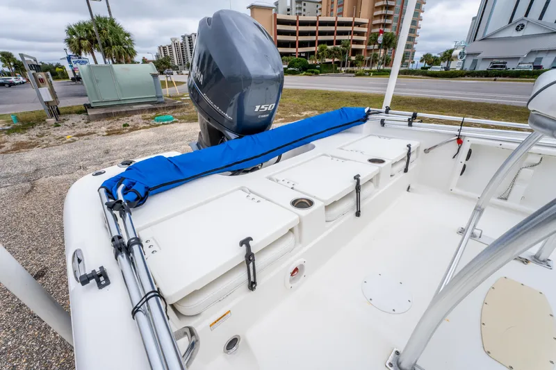 Slide: The Image of 2014 NauticStar 214 XTS boat with Yamaha 150 engine, docked near buildings. - 19