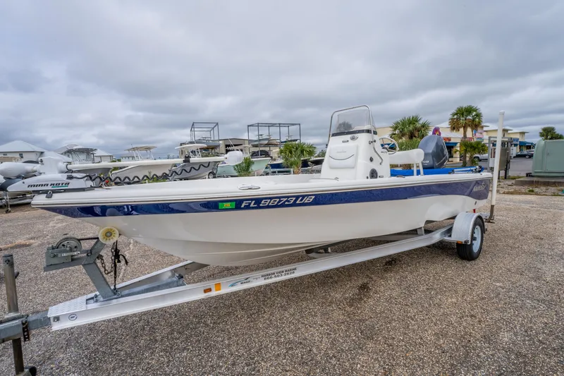 Slide: The Image of 2014 NauticStar 214 XTS boat on trailer in a marina setting. - 4