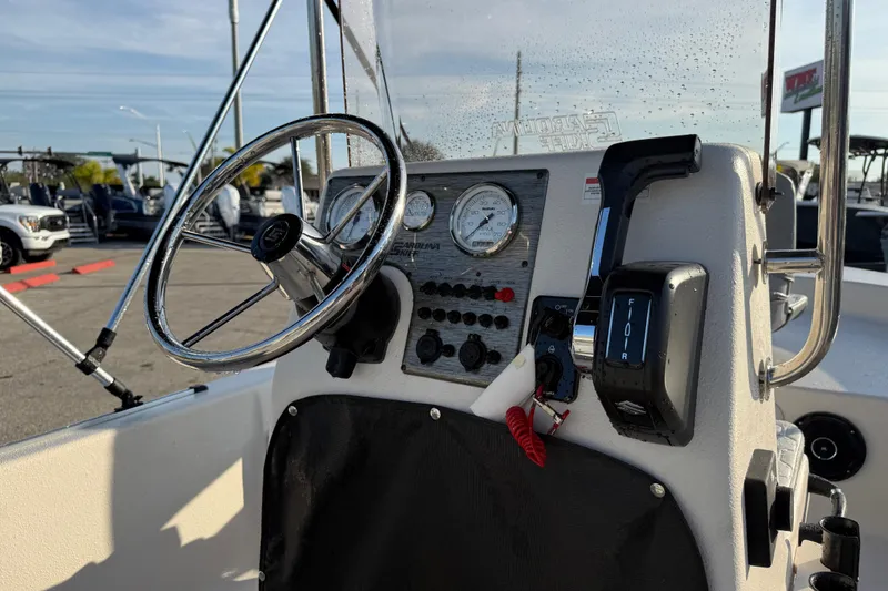 Slide: The Image of 2026 Carolina Skiff E16 JVX CC boat console with steering wheel and controls. - 13