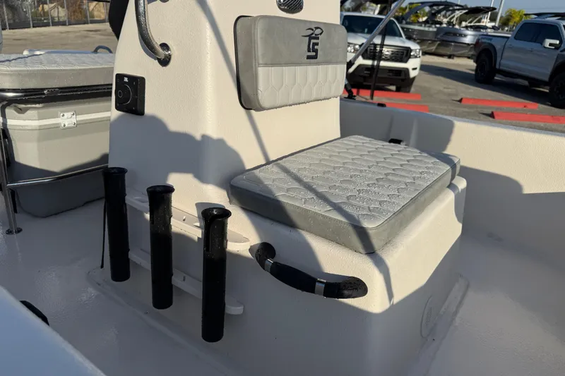 Slide: The Image of 2026 Carolina Skiff E16 JVX CC boat interior with cushioned seating and rod holders. - 15