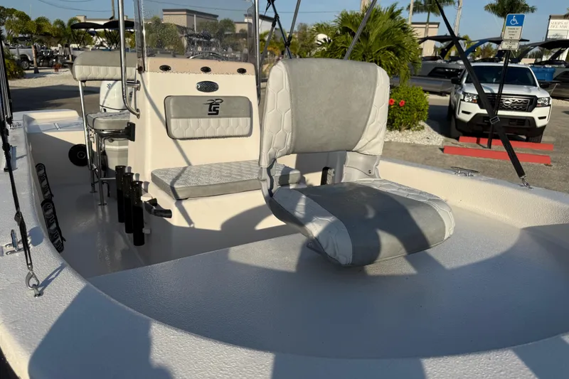 Slide: The Image of 2026 Carolina Skiff E16 JVX CC boat interior with seating and fishing rod holders. - 19
