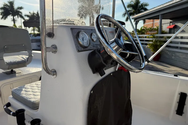 Slide: The Image of 2026 Carolina Skiff E16 JVX CC boat console with steering wheel and gauges. - 23