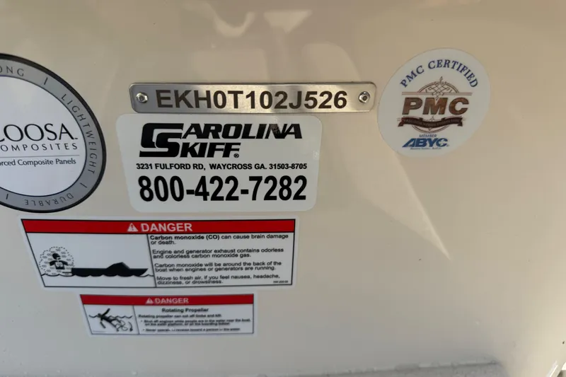 Slide: The Image of 2026 Carolina Skiff E16 JVX CC boat identification and safety warning labels. - 25