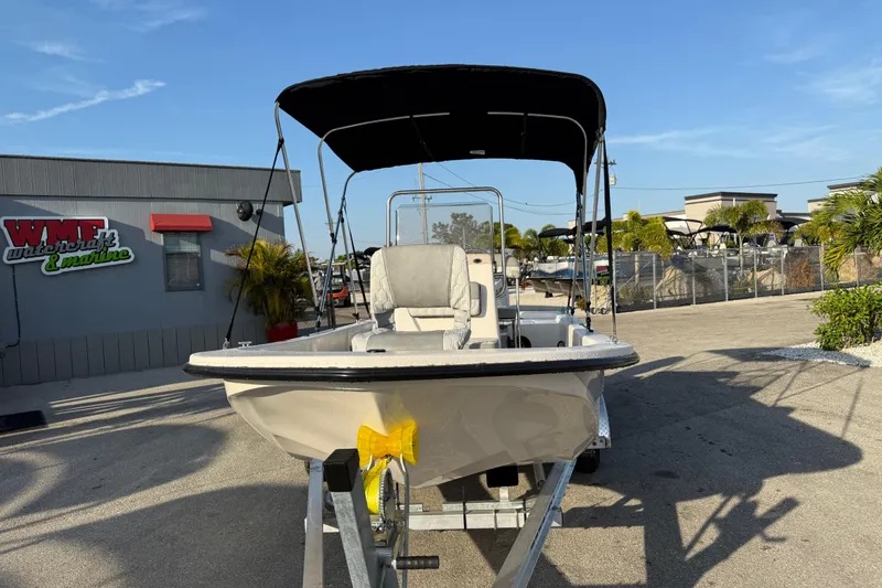 Slide: The Image of 2026 Carolina Skiff E16 JVX CC boat on trailer at marine dealership. - 4